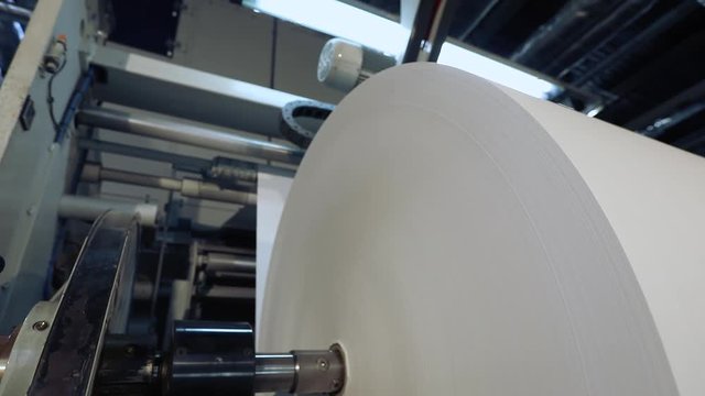Large roll of paper for the production of wallpaper, a modern factory for the production of wallpaper