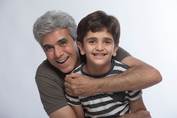 Happy grandfather hugging his grandson	