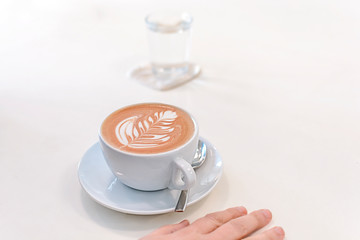 Cup of mokka in big white coffee on wooden white table