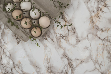Easter eggs on marble background. A sprig of greenery.Place for inscription. top view
