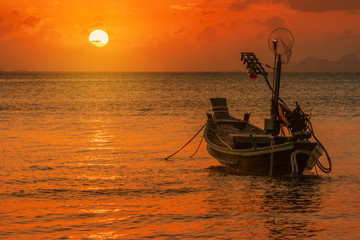          Silhouette longtail boat moor on tropical beach  at fisherman village during sunset time Samui, Thailand 