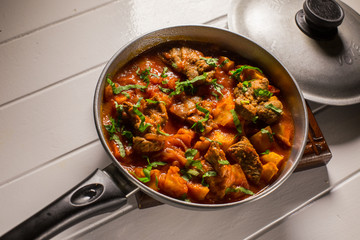 Stuffed meat with potatoes in a tomato sauce on a boiler