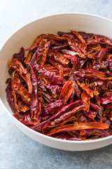 Stack of Dried Red Chili or Chilli Cayenne Pepper in Bowl.
