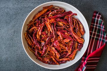 Stack of Dried Red Chili or Chilli Cayenne Pepper in Bowl.