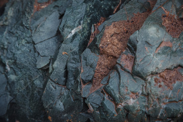 The texture of blue - turquoise stone with relief. Abstract background for design. wet stone