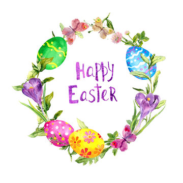 Colored eggs in grass, crocus flowers, butterflies. Easter wreath, card. Floral circle border, text Happy Easter . Watercolor