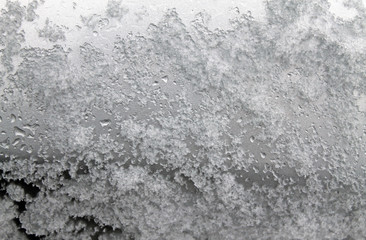 Fototapeta na wymiar melting snow on the glass. sleet on glass