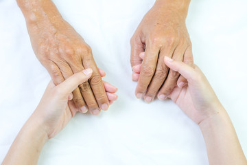 Obraz premium Asian senior and asian young holding hands.