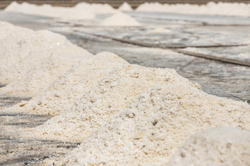 Close up piles of raw white sea salt in the salt farm samut songkhram province, Thailand on sunny day