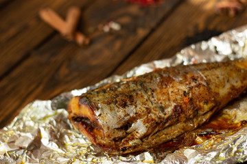 Baked mackerel with spices on a rough wooden background
