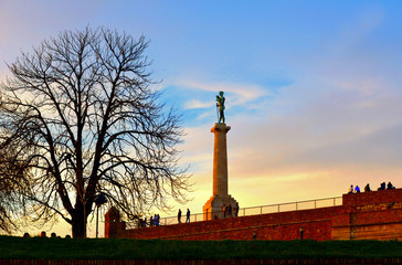 Obraz premium colorful blue sky with clouds and light on Viktor statue and people on the wall in Kalemegdan fortress in Belgrade Serbia