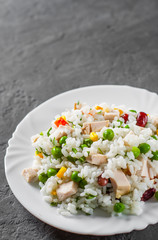 Chicken Breast with Rice and vegetables in white plate on Dark grey black slate background