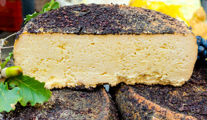 pecorino sheep cheese on wooden block, white background
