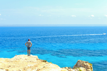 beach Cala Bue Marino on Favignana Island with small boats and Island Marettimo in background, Sicily Italy