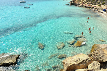 beach Cala Azzurra on Favignana Island with small boats and Island Marettimo in background, Sicily Italy