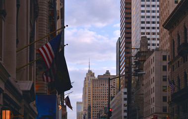 NEW YORK   View to the famous 5th avenue street with american flag, modern skyscrapers and old buildings in Midtown Manhattan 