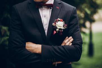 groom or groomsmen closeup, bow tie and boutonniere on suit, confident stylish man - obrazy, fototapety, plakaty