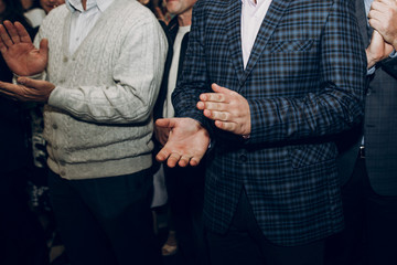 people applauding, clapping hands at wedding reception or meeting