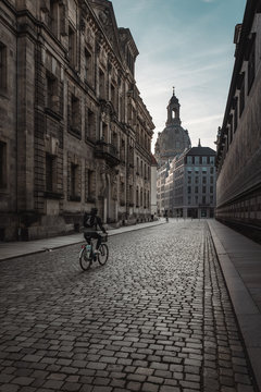 Man riding bike in old town, Dresden, Germany