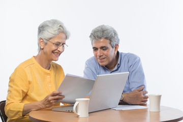 Senior couple using laptop	