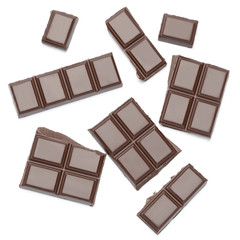 Dark organic chocolate pieces isolated on white background