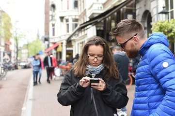 couple in the street with mobile phone