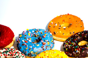 Sweet tasty donuts with colorful sprinkles isolated on white background