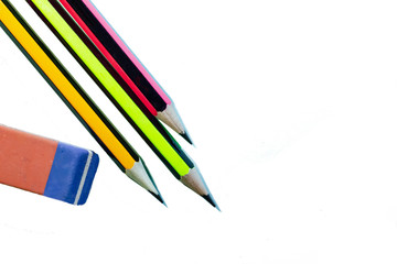 pencils and eraser on white background