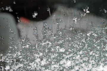melting snow on the glass. sleet on glass