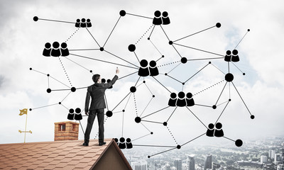Businessman on house roof presenting networking and connection c