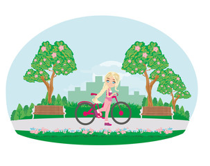 Obraz na płótnie Canvas sweet girl on a bike in the park