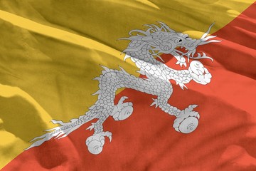 Waving Bhutan flag for using as texture or background, the flag is fluttering on the wind