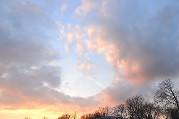 Rapturous sunset cloudy sky, with beautiful pastel shades and dramatic cumulo nimbus clouds.