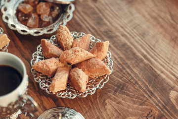 Turkish sweets with coffee on a wooden table