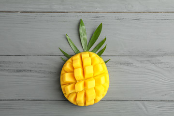 Fototapeta na wymiar Fresh tropical ripe mango on grey background, top view