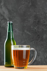 Single beer glass close up on dark stone background