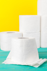 Toilet paper stacks  on bright yellow background
