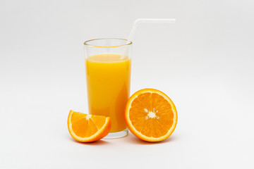 glass of orange juice and sliced orange on a white background