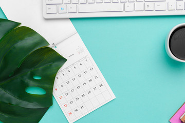 Top view flat lay of workspace desk styled design office supplies with calendar