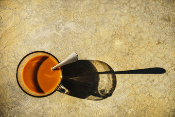 Top view of coffee mug placed on the concrete floor, Cup of coffee, vintage style.