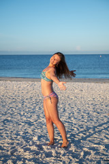 Fototapeta na wymiar Young woman posing at the beach