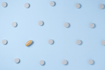 Pills pattern on blue pastel coloured background, Top view