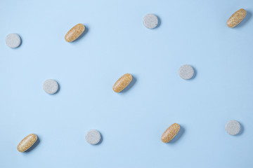 Pills pattern on blue pastel coloured background