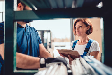 Stock clerk checking warehouse inventory