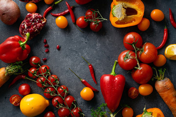 Flatlay with colorful vegetables and copy space. Frame shape. Sliced butternut squash, cherry tomatoes, bell peppers, pomegranate and onion. Healthy food variety.