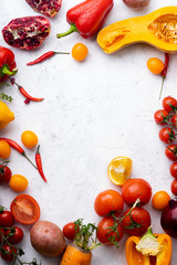 Flatlay with colorful vegetables and copy space arranged on white background. Frame shape with space in centre. Vegan nutrition concept