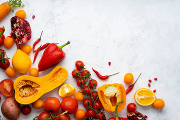 Flatlay with colorful vegetables and copy space arranged on white background. View from above. Vegan nutrition concept