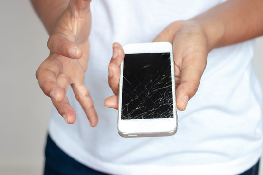 Woman holding phone That dropped the screen, cracked in the hand ,Very sad.