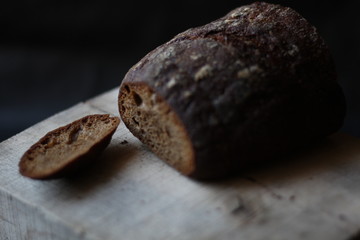 rye bread on a wooden background with a cut off crust
