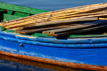 Old fishing boats with bright colors at dawn on the lake.